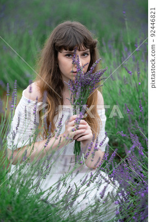 A smiling woman with lavender A smiling woman with lavender 92446821