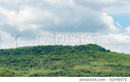 Wind energy. Wind power. Sustainable, renewable energy. Wind turbines generate electricity. Windmill farm on a mountain with blue sky. Green technology. Renewable resource. Sustainable development. 92446978