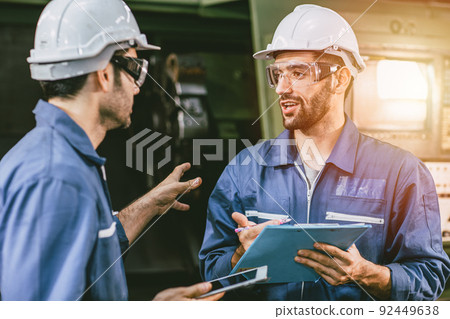Engineer staff worker talking discussion help working team together with metal machine industry in factory. Engineer staff worker talking discussion help working team together with metal machine industry in factory. 92449638
