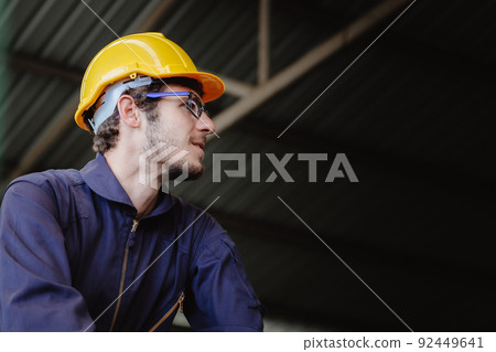 Portrait of young American happy worker in safety clothes engineer hardhat helmet with copy space. 92449641