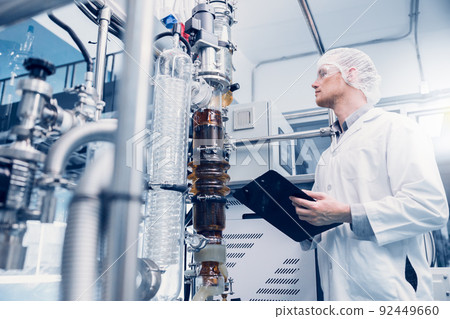 Science lab medical factory staff working for Cannabis CBD oil extraction. Hemp oil extraction Thin Film Distillation Laboratory Plants Process. 92449660