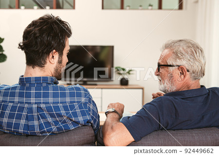 elderly father with son man talking discuss understanding together at home sofa. elderly father with son man talking discuss understanding together at home sofa. 92449662