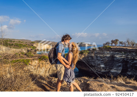 Man and woman in honeymoon near Broken Beach in Nusa Penida, Indonesia Angel's BillaBong Beach. Popular tourist destination Bali 92450417