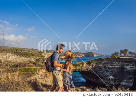 Man and woman in honeymoon near Broken Beach in Nusa Penida, Indonesia Angel's BillaBong Beach. Popular tourist destination Bali Man and woman in honeymoon near Broken Beach in Nusa Penida, Indonesia Angel's BillaBong Beach. Popular tourist destination Bali 92450418