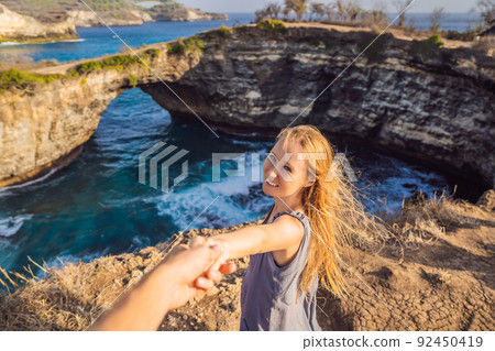 Young woman tourist near Broken Beach in Nusa Penida, Indonesia Angel's BillaBong Beach. Popular tourist destination Bali 92450419