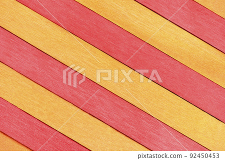 The surface of alternating red and orange wooden planks arranged diagonally. The surface of alternating red and orange wooden planks arranged diagonally. 92450453