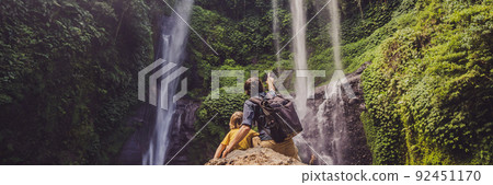 Dad and son at the Sekumpul waterfalls in jungles on Bali island, Indonesia. Bali Travel Concept BANNER, LONG FORMAT 92451170