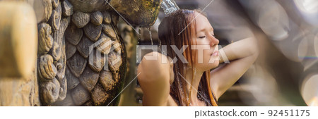 Young woman in hot springs banjar. Thermal water is released from the mouth of statues at a hot springs in Banjar, Bali, Indonesia BANNER, LONG FORMAT Young woman in hot springs banjar. Thermal water is released from the mouth of statues at a hot springs in Banjar, Bali, Indonesia BANNER, LONG FORMAT 92451175