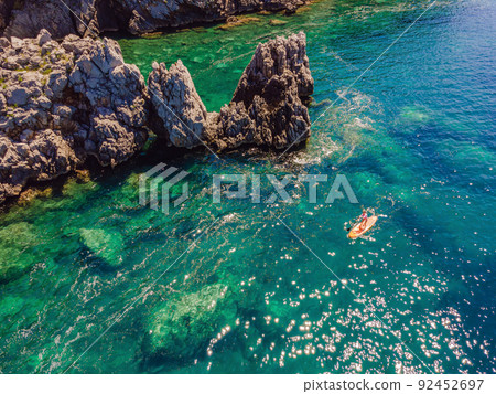 Young women Having Fun Stand Up Paddling in blue water sea in Montenegro. SUP. girl Training on Paddle Board near the rocks Portrait of a disgruntled girl sitting at a cafe table Young women Having Fun Stand Up Paddling in blue water sea in Montenegro. SUP. girl Training on Paddle Board near the rocks Portrait of a disgruntled girl sitting at a cafe table 92452697