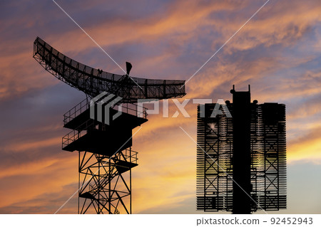 Air defense radars of military mobile anti aircraft systems (radar is designed  and automatic tracking of targets and missiles) , on the background of the sunset orange sky, Russia 92452943