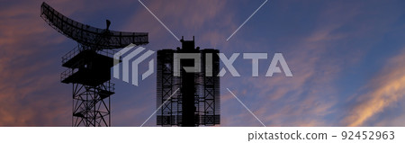 Air defense radars of military mobile anti aircraft systems (radar is designed  and automatic tracking of targets and missiles) , on the background of the sunset orange sky, Russia 92452963