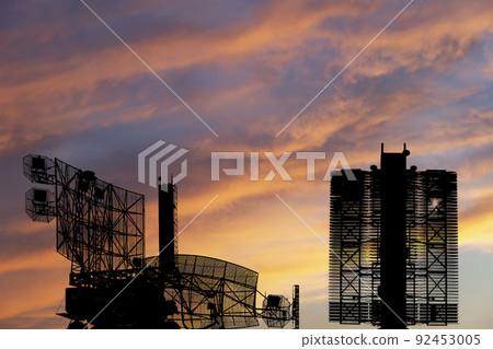 Air defense radars of military mobile anti aircraft systems (radar is designed  and automatic tracking of targets and missiles) , on the background of the sunset orange sky, Russia 92453005