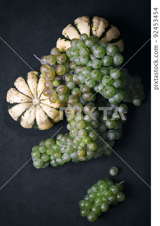 Still life with two decorative pumpkins and bunches of grapes 92453454
