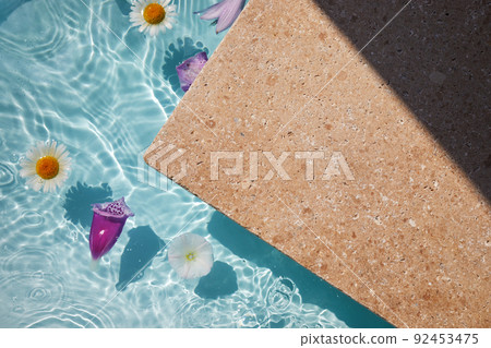 Product promotion Beauty cosmetic showcase. Travertine stone display with flowers in water. 92453475