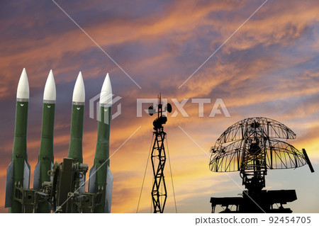 Air defense radars of military mobile anti aircraft systems and modern Russian anti-aircraft missiles OSA-AKM on the background of the sunset orange sky,Russia 92454705