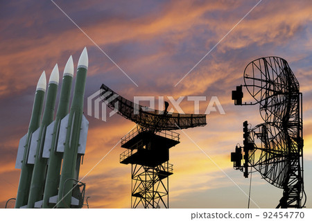 Air defense radars of military mobile anti aircraft systems and modern Russian anti-aircraft missiles OSA-AKM on the background of the sunset orange sky,Russia 92454770