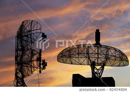 Air defense radars of military mobile anti aircraft systems, modern army industry on the background of the sunset orange sky, Russia 92454804
