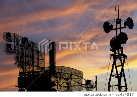 Air defense radars of military mobile anti aircraft systems, modern army industry on the background of the sunset orange sky, Russia Air defense radars of military mobile anti aircraft systems, modern army industry on the background of the sunset orange sky, Russia 92454817