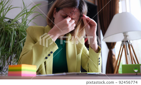 Tired office manager sitting at workplace in office 92456774
