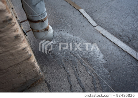 Rainy weather concept. Drainpipe through which water flows from rain that has just begun. 92456826