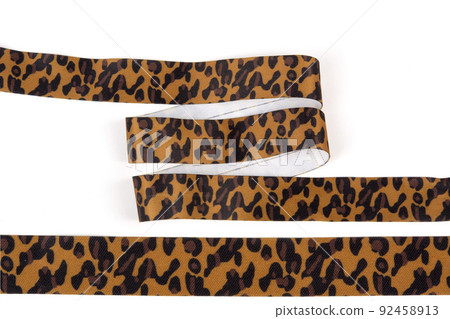 knit stripes elastic ribbon band, webbing, herringbone tapes, lustrous yarn for clothes, trousers, jackets. Stripe and zigzag. elastic sewing material on a white background 92458913