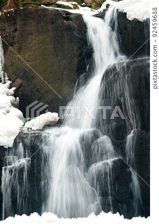 A small active waterfall. Clean mountain stream, snowy winter landscape, wildlife background A small active waterfall. Clean mountain stream, snowy winter landscape, wildlife background 92459688