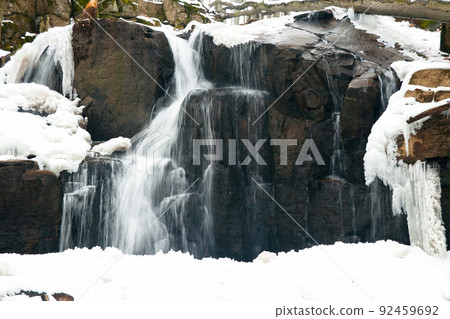 A small active waterfall. Clean mountain stream, snowy winter landscape, wildlife background A small active waterfall. Clean mountain stream, snowy winter landscape, wildlife background 92459692
