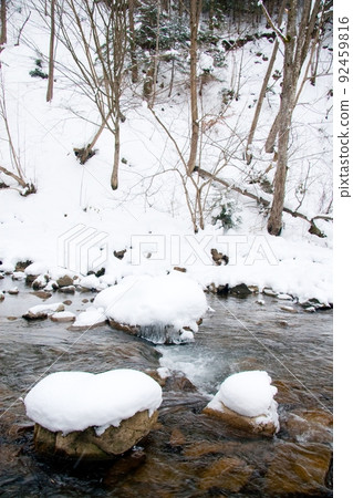 A small active waterfall. Clean mountain stream, snowy winter landscape, wildlife background A small active waterfall. Clean mountain stream, snowy winter landscape, wildlife background 92459816