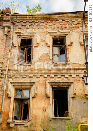 ruins. broken glass in windows of an old ruined building. ruins. broken glass in windows of an old ruined building. 92461182