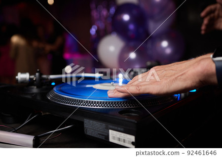 DJ behind the decks in a nightclub. DJ spinning plate. people dancing in a nightclub. disco. 92461646