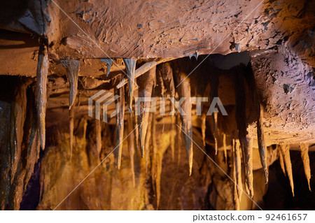 Ancient runes on the wall of the cave, weathered by time The old inscription to the descendants. 92461657