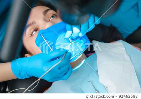 Closeup shot of a female patient with a cofferdam system in a modern dental office. Dental equipment 92462588