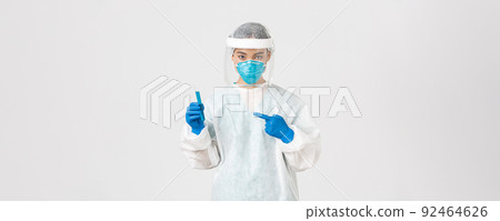 Covid-19, coronavirus disease, healthcare workers concept. Portrait of serious confident, asian female researcher, tech lab employee in personal protective equipment holding vaccine in test-tube 92464626