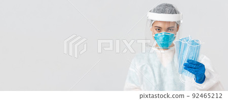 Covid-19, coronavirus disease, healthcare workers concept. Confident serious-looking female asian doctor in personal protective equipment insist patient wearing medical masks, white background 92465212