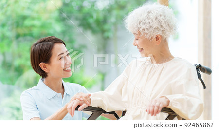 Caregiver and woman in a wheelchair 92465862