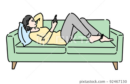 A woman lying on the sofa and looking at her smartphone A woman lying on the sofa and looking at her smartphone 92467130