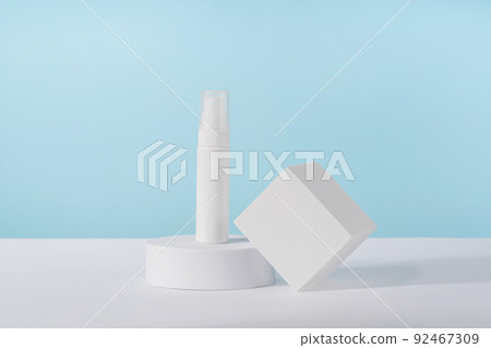 Cosmetic cream bottle mockup on blue background on pedestal podium. Unbranded lotion beauty product packaging. Product presentation mock up. Lotion, cleanser, shampoo for skincare routine Cosmetic cream bottle mockup on blue background on pedestal podium. Unbranded lotion beauty product packaging. Product presentation mock up. Lotion, cleanser, shampoo for skincare routine 92467309