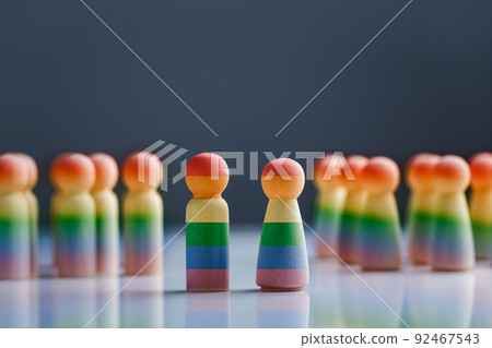 Wooden doll painted with rainbow flags. LGBT Rights concept. Wooden doll painted with rainbow flags. LGBT Rights concept. 92467543