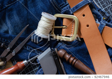 Leather belt brass buckle on jean pant 92467946