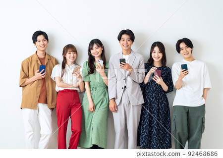 Men and women Gen Z friends college students share house smartphone white background 92468686