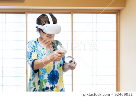Senior woman experiencing virtual reality in VR 92469031
