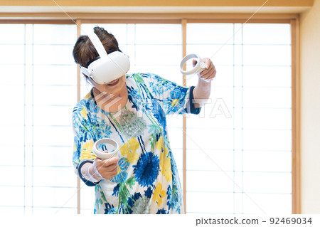 Senior woman experiencing virtual reality in VR 92469034
