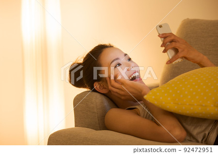 Female lying on the couch Female lying on the couch 92472951