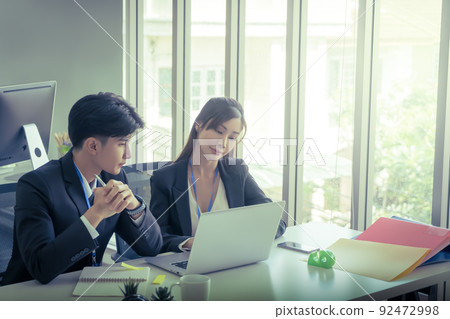 Two Business people is discussing work on notebook laptop in office with serious gesture. Two Business people is discussing work on notebook laptop in office with serious gesture. 92472998