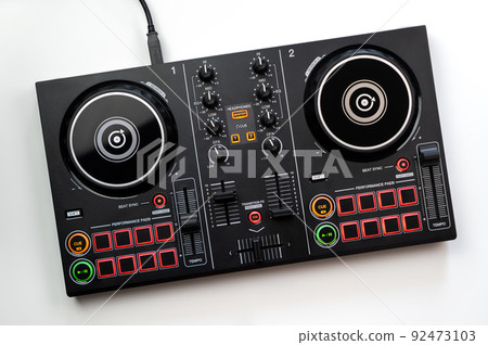 DJ Colorful mixing deck Controller connecting to Laptop and tablet using USB cable top view, isolated on white. 92473103
