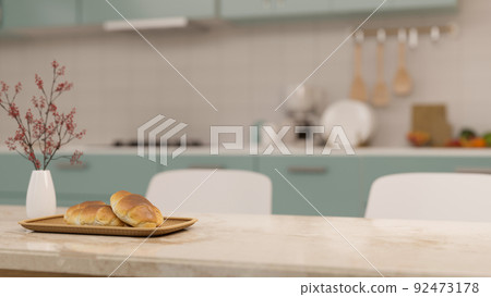 Modern marble dining tabletop with copy space over blurred minimal home kitchen cooking space Modern marble dining tabletop with copy space over blurred minimal home kitchen cooking space 92473178