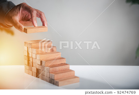 Business hand arranging put wooden block stacking step stair growth success process 92474769