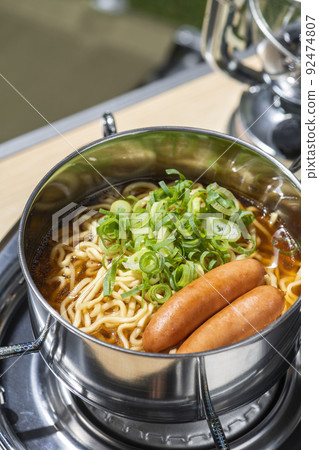 Eat instant noodles at an outdoor camp Eat instant noodles at an outdoor camp 92474807