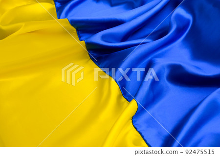 Fabric wave flag of Ukraine, UA. Blue and yellow bright colors. Curved texture background 92475515