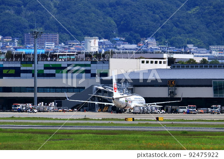 Osaka International Airport, a passenger plane taking off and landing Osaka International Airport, a passenger plane taking off and landing 92475922